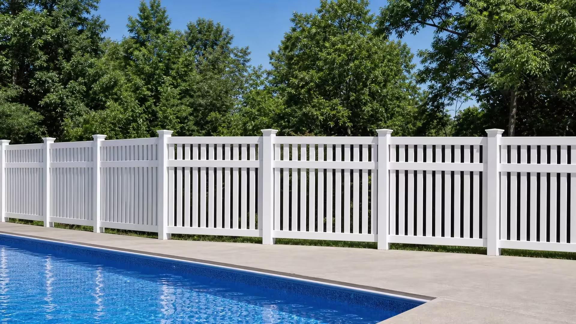 Long lower boards and a row of shorter upper pickets combine on this White vinyl pool fence above two rail bands