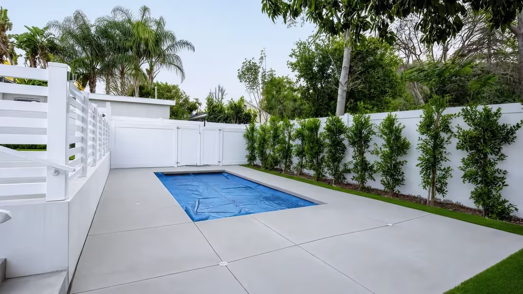 White vinyl pool fence combining an open horizontal-rail run with a hinged panel gate and visible latch hardware