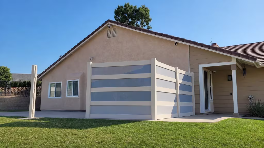 Front porch marks the end of this Tan vinyl privacy fence with blue gray acrylic bands