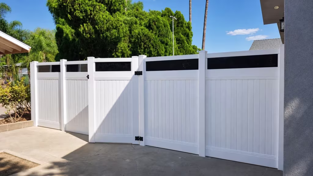 Concrete side yard holds this White vinyl privacy fence with acrylic and a pedestrian gate bay