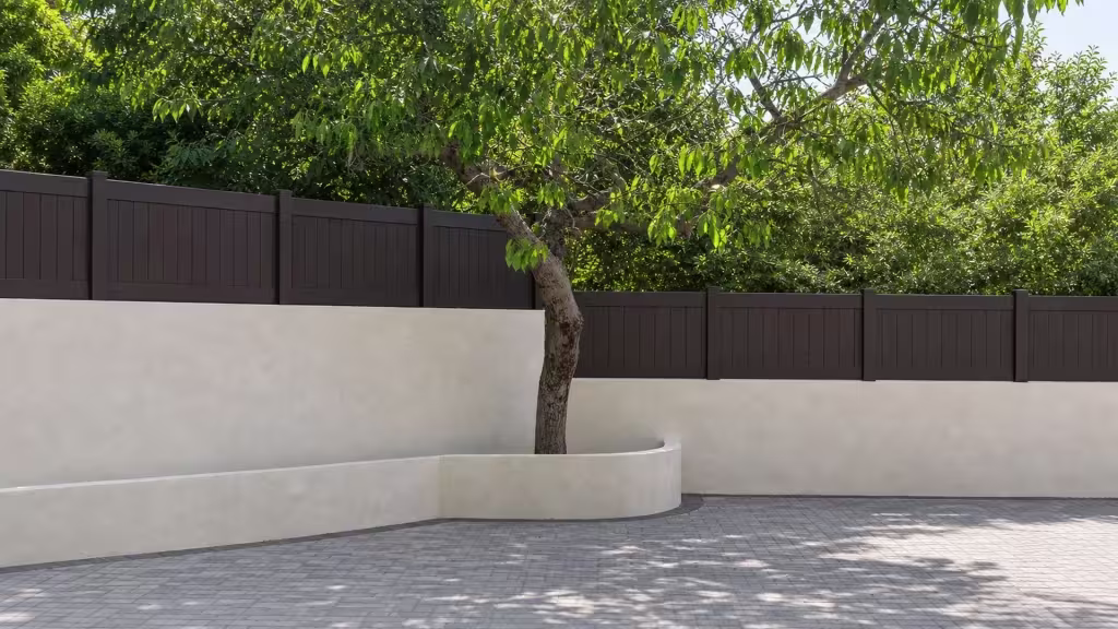 Mature courtyard tree partly screens a Dark Walnut vinyl wall topper above a curved planter and gray pavers