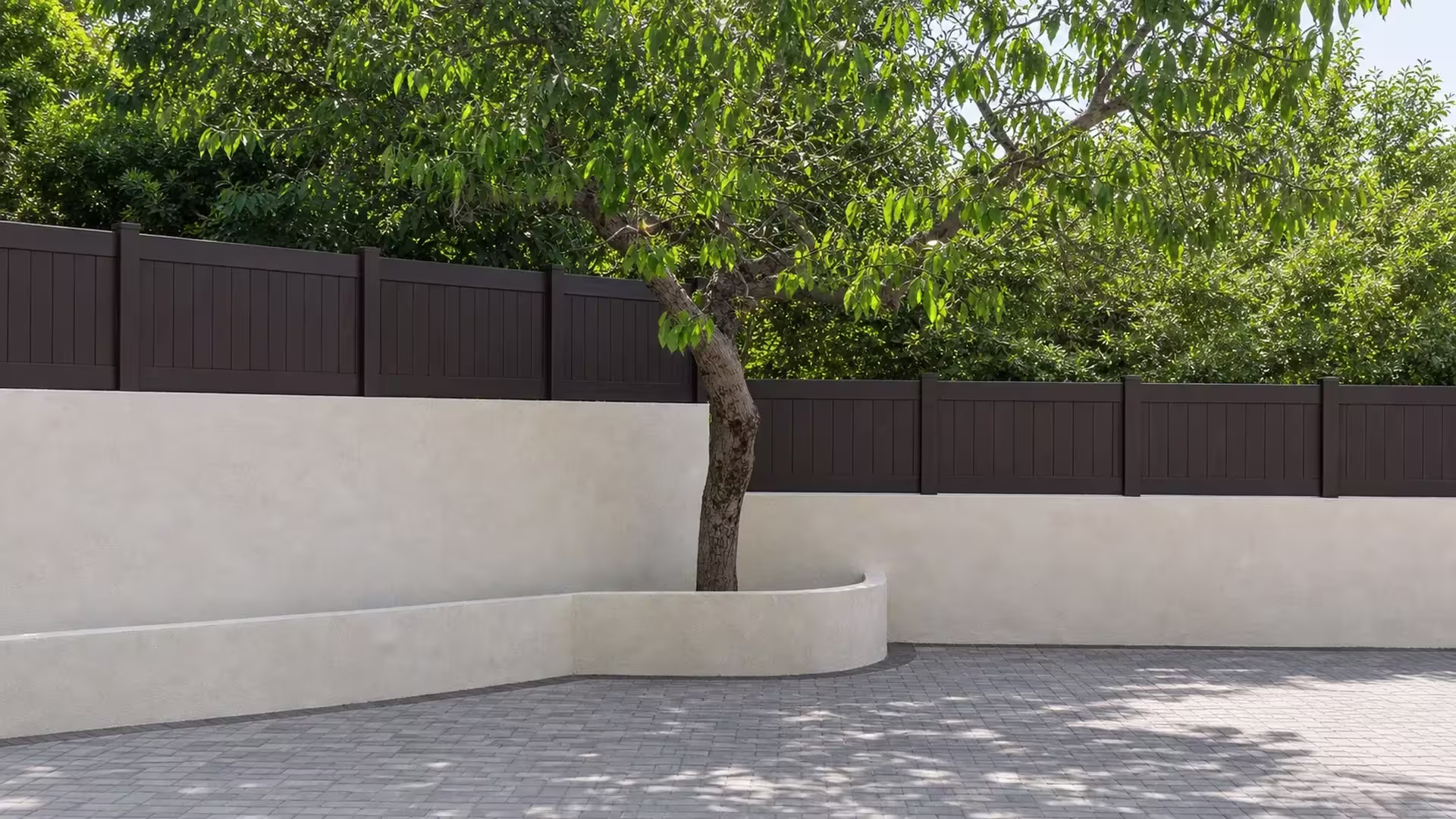 Mature courtyard tree partly screens a Dark Walnut vinyl wall topper above a curved planter and gray pavers