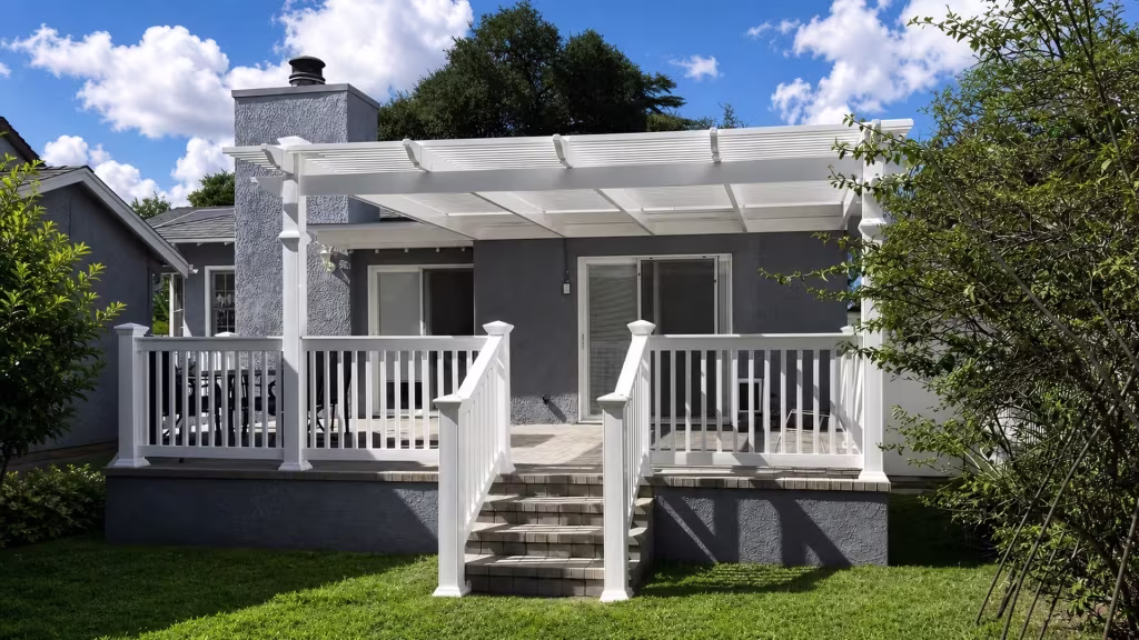 A coordinated patio cover pairs with White vinyl porch and stair railing on a gray stucco house
