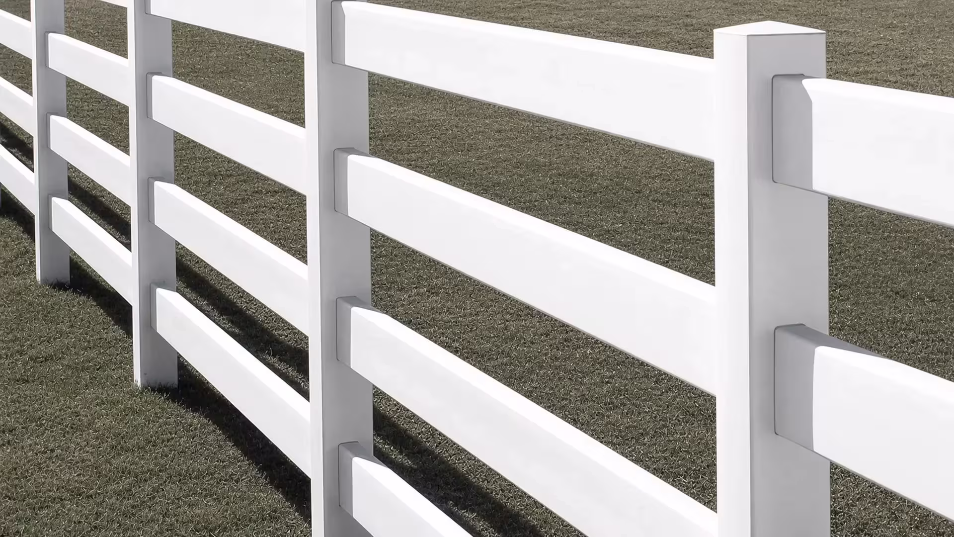 Faceted pyramid caps sit above open gaps between four White vinyl rails on this ranch fence