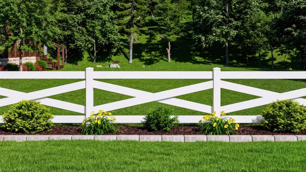 A mulched bed of yellow flowers sits beside a wooden stair structure near this White vinyl cross rail fence