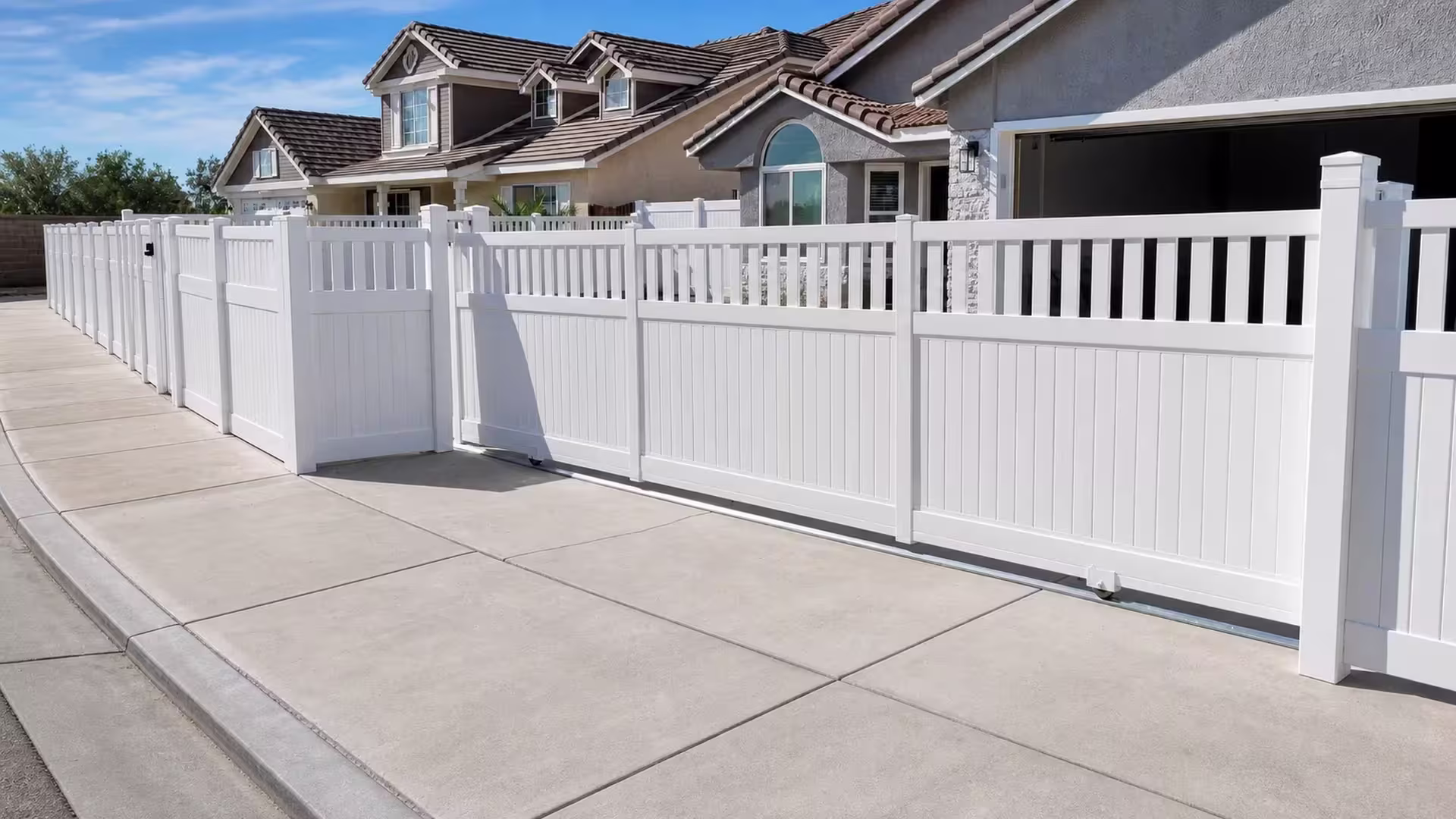 Solid privacy boards and open pickets share two matched bays on this White vinyl rolling gate