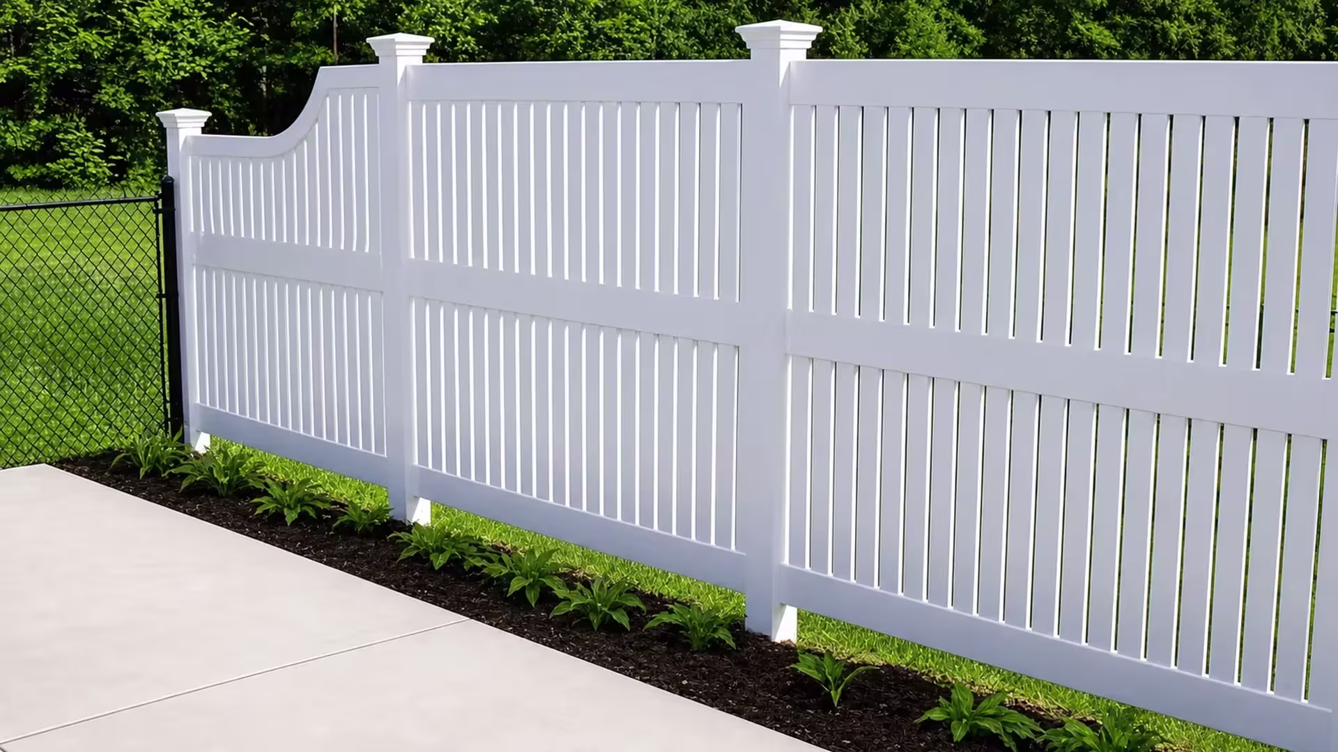 Curved rise in the grade lifts this White vinyl semi-privacy fence past a black chain-link boundary line