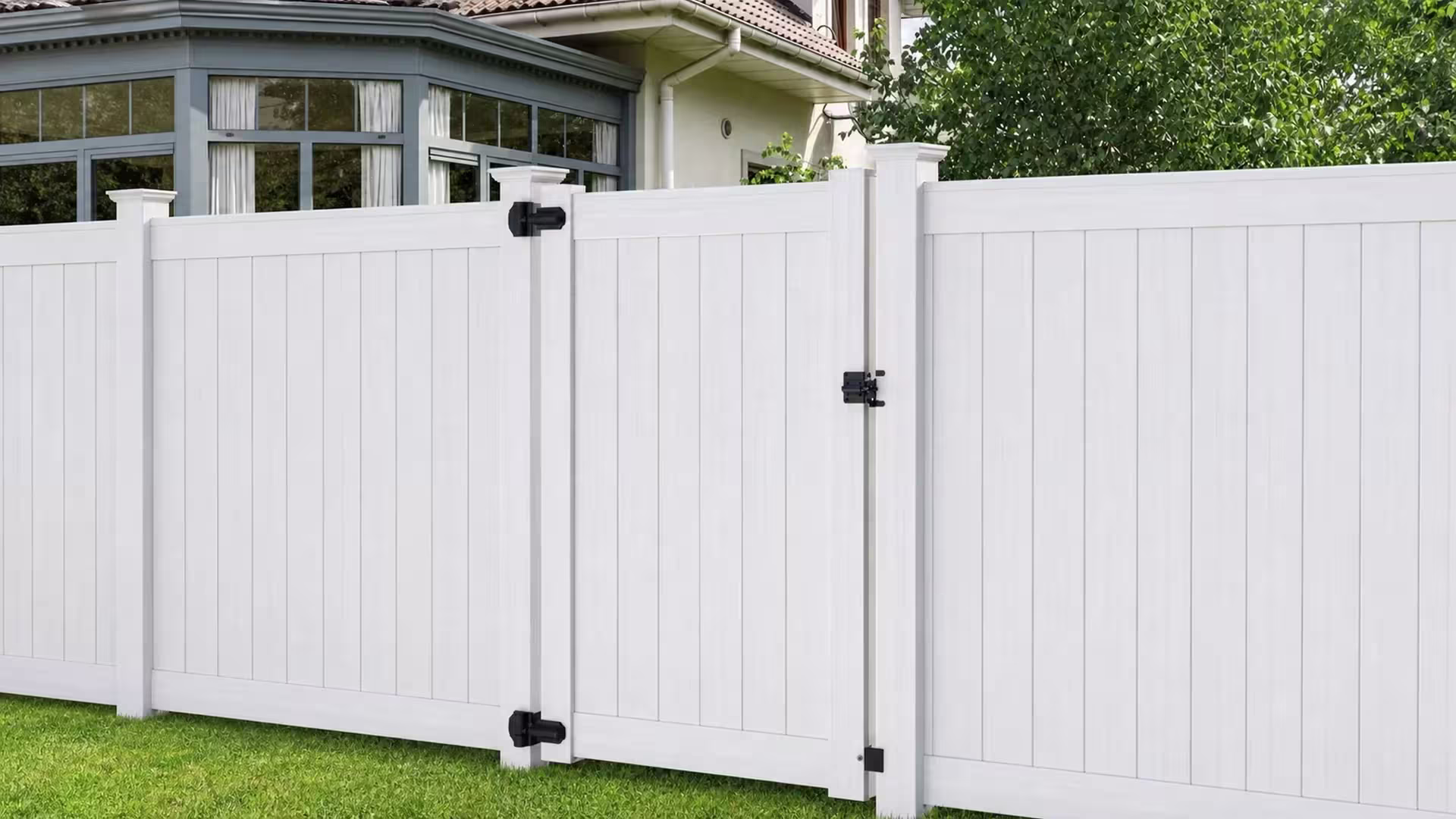 Black strap hinges secure this tall White vinyl side gate beneath a mature tree canopy
