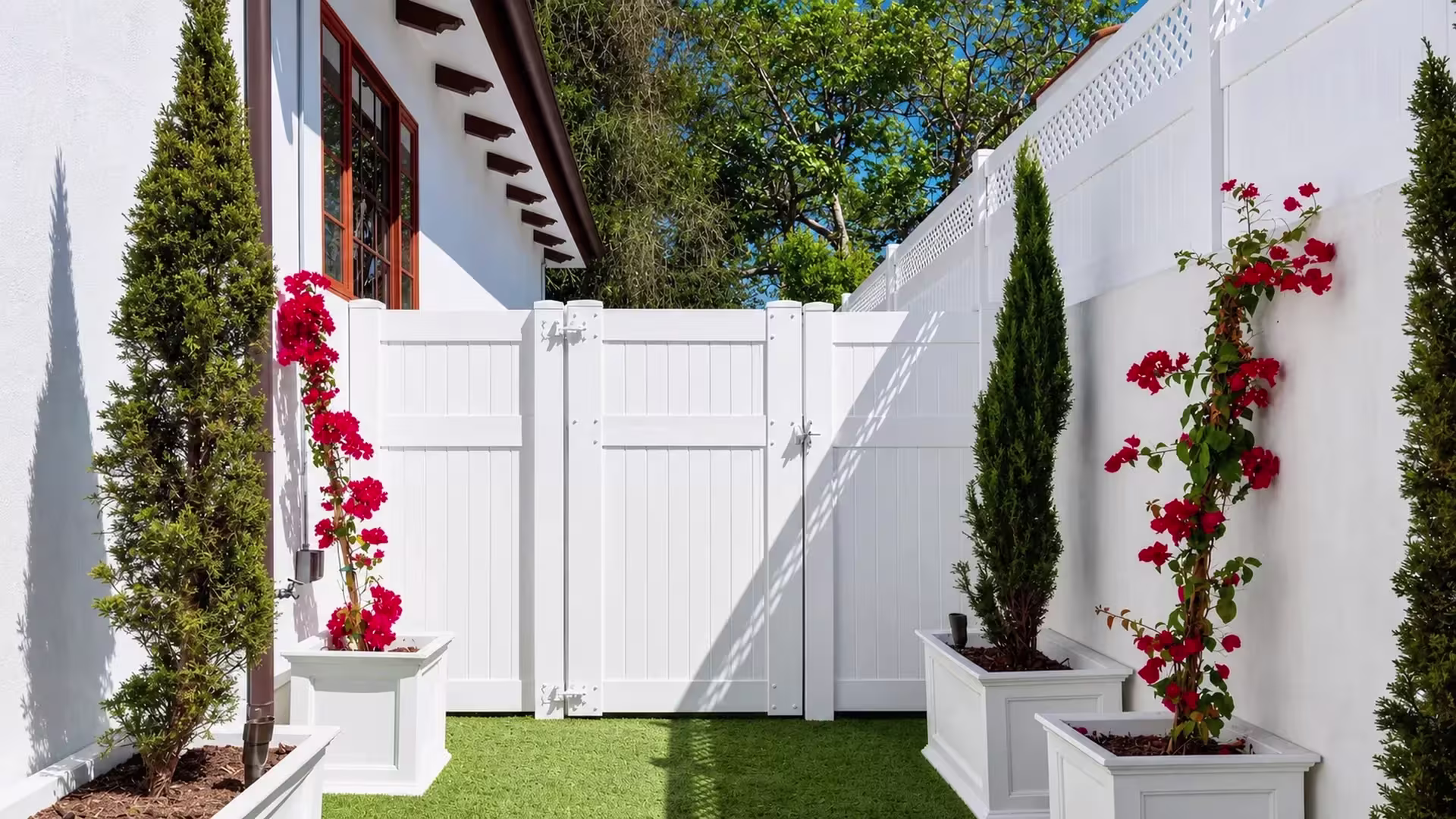 Two fixed privacy sections flank this White vinyl side gate leaf across an open courtyard