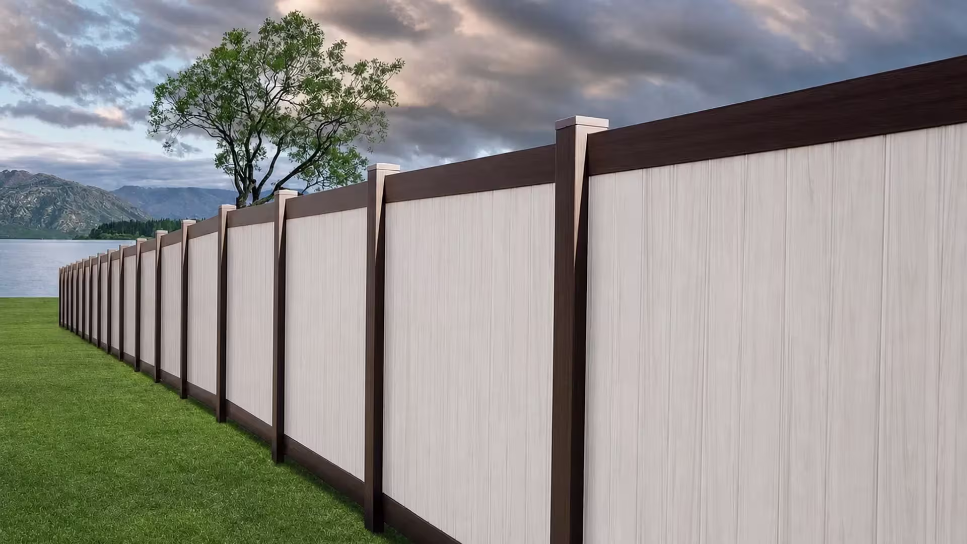 White vinyl two-tone fence descending in a straight run beside a sloped lawn