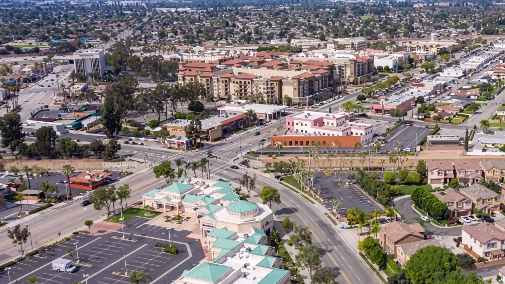 West Covina's commercial center anchors a valley ringed by residential neighborhoods, seen from above