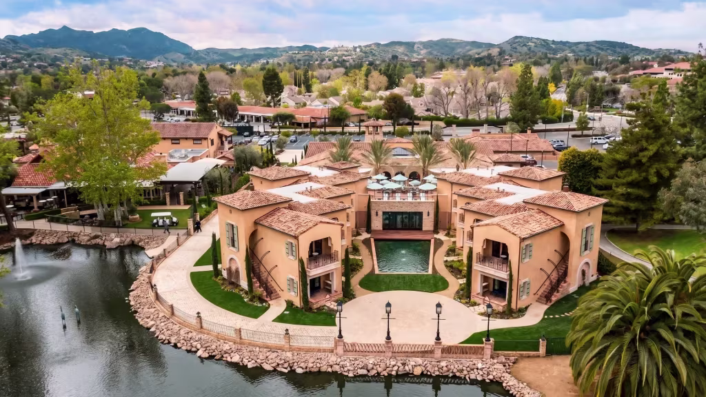 Lakeside homes and a landscaped waterfront estate line the water's edge in Westlake Village