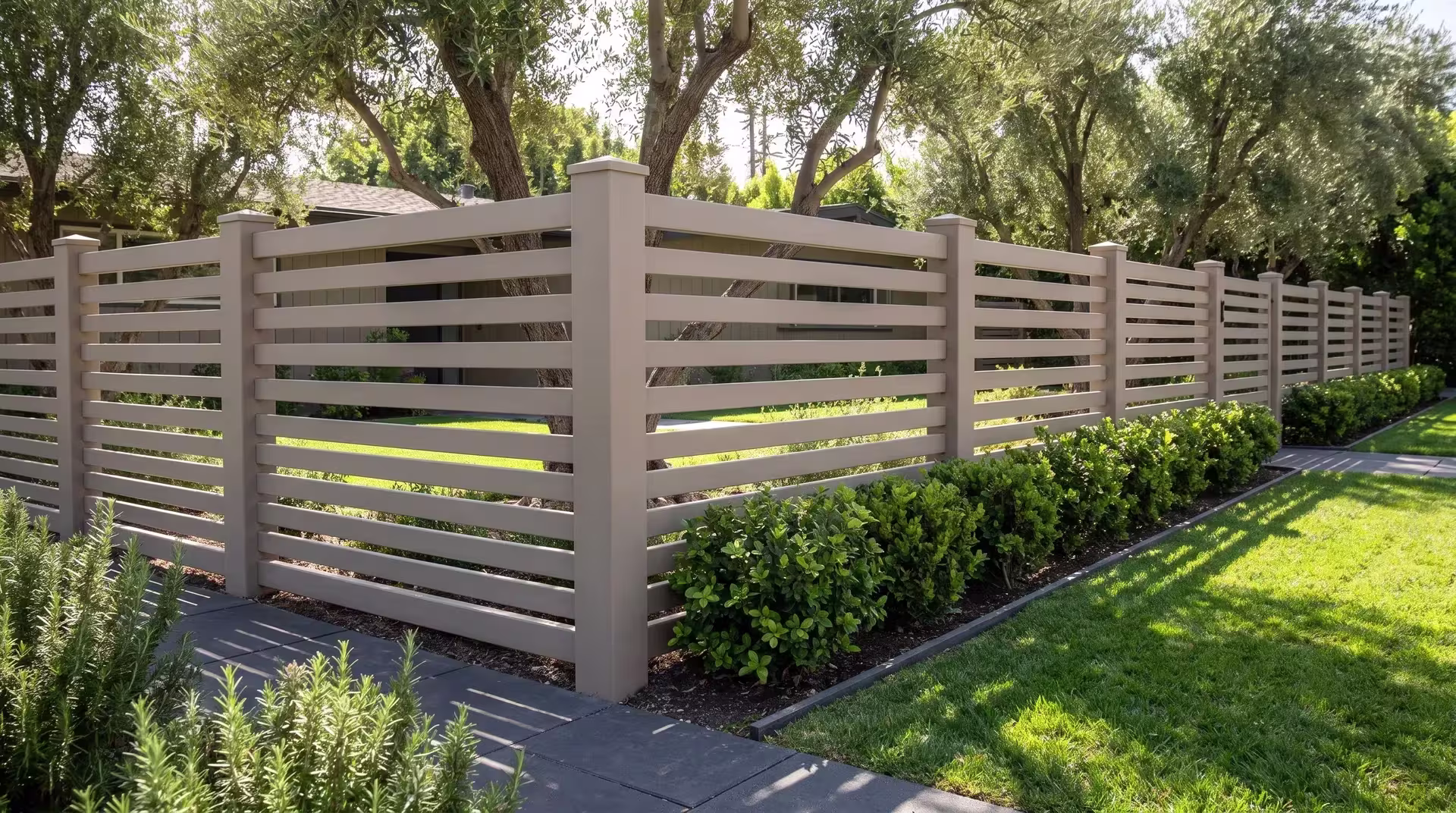 Clay vinyl horizontal picket fence bordering a drought-aware garden of clipped pittosporum and rosemary