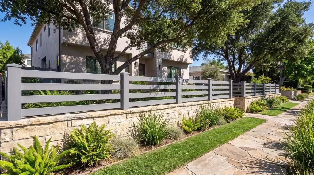 Slate Gray vinyl horizontal picket topper set beside a flagstone walk threaded through ferns and lomandra