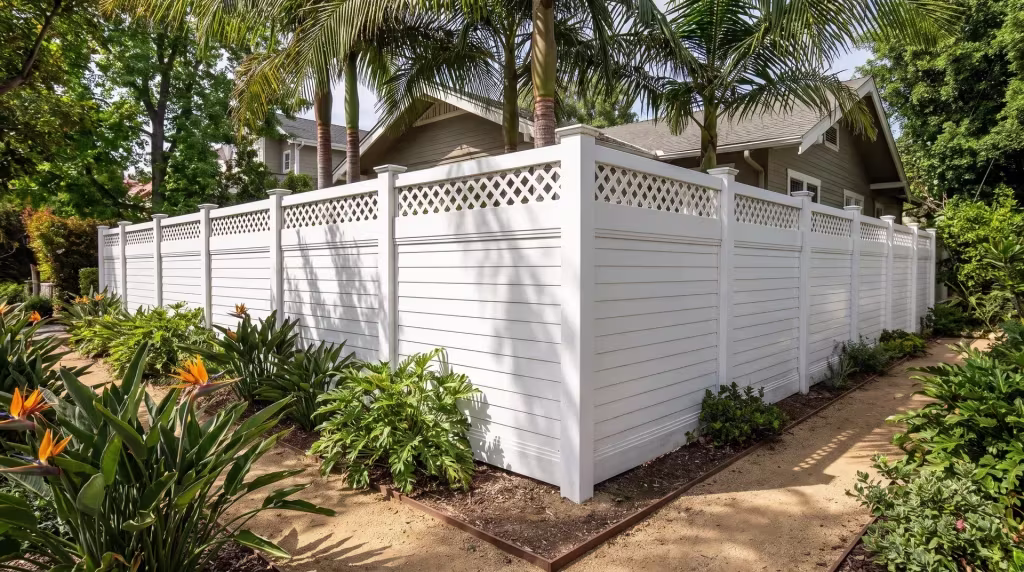 Decomposed-granite paths lead to White vinyl horizontal privacy fencing stepped down a terraced hillside yard