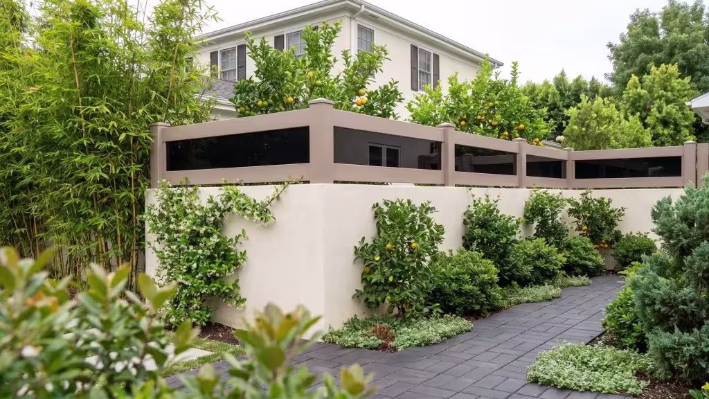 Clay vinyl wall topper with acrylic capping a pale stuccoed garden wall for extra privacy behind bamboo screening
