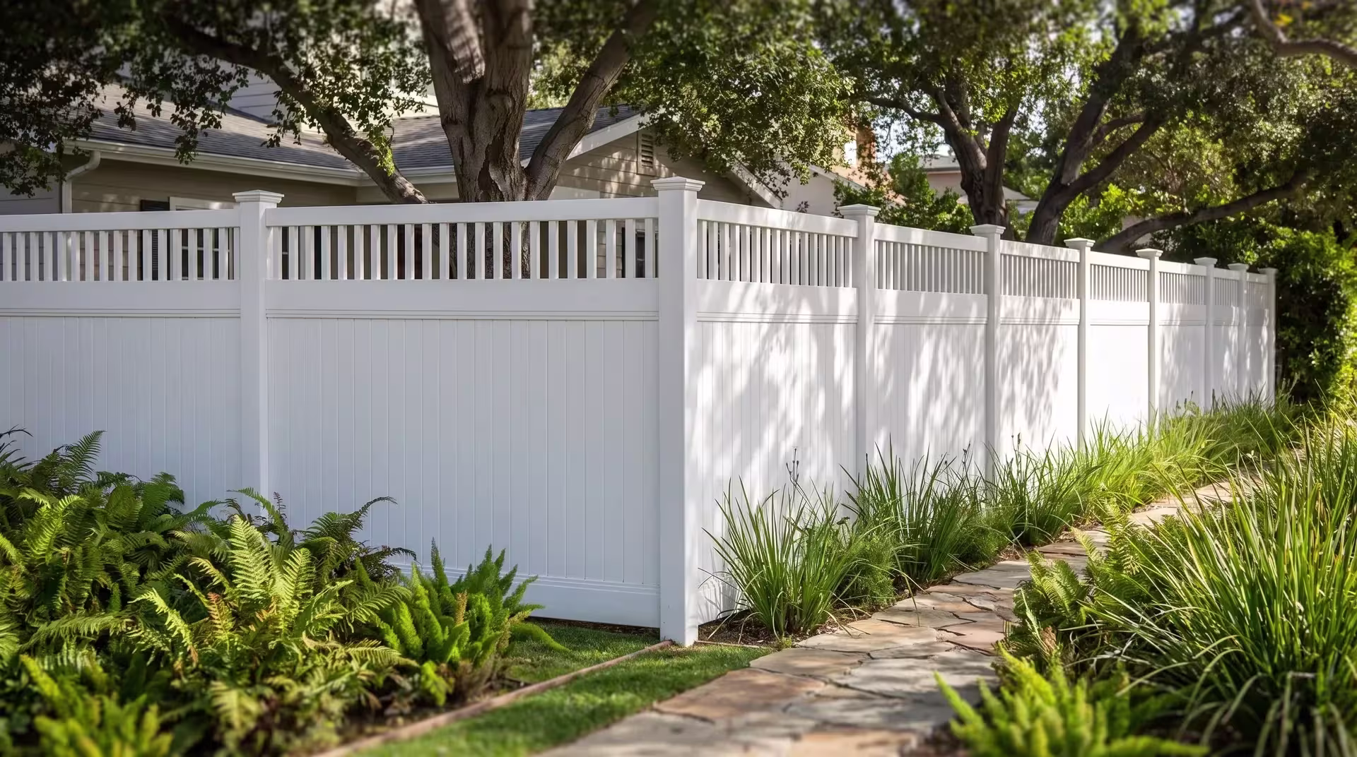Coast live oak shade falls across this vinyl fence, finished in White, turning the corner with a picket top