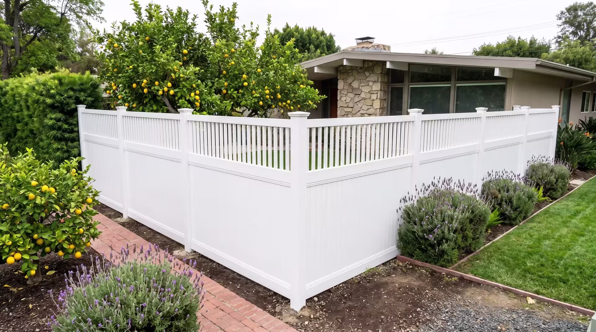 Lemon trees and lavender edge the corner where this vinyl fence, finished in White, meets a ranch home's picket top